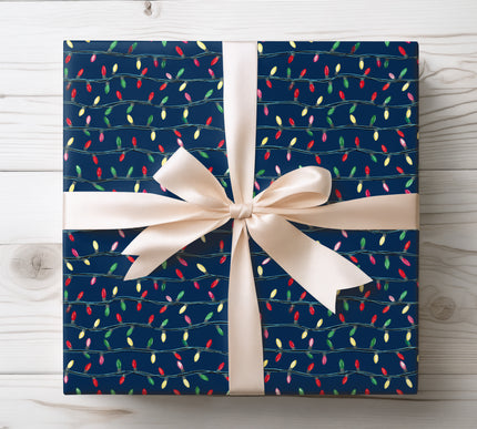 Vibrant multicolor Christmas lights tangled across a deep navy background, perfect for festive wrapping. 