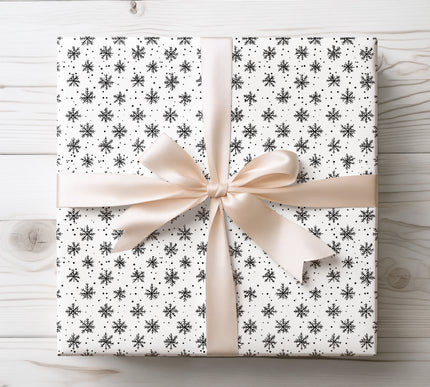 Delicate hand-drawn snowflakes scattered across the paper, ideal for winter and holiday-themed gifts. 
