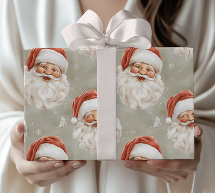 Merrywink Whimsy – Winking and smiling Santa faces on snowy beige background wrapping paper