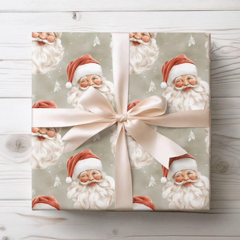 Merrywink Whimsy – Winking and smiling Santa faces on snowy beige background wrapping paper