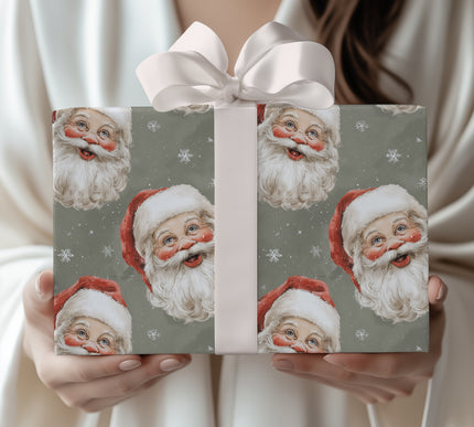 RetroClaus – Vintage Santa faces with snowflakes on a muted green background Wrapping Paper