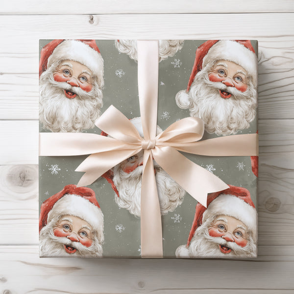 RetroClaus – Vintage Santa faces with snowflakes on a muted green background Wrapping Paper