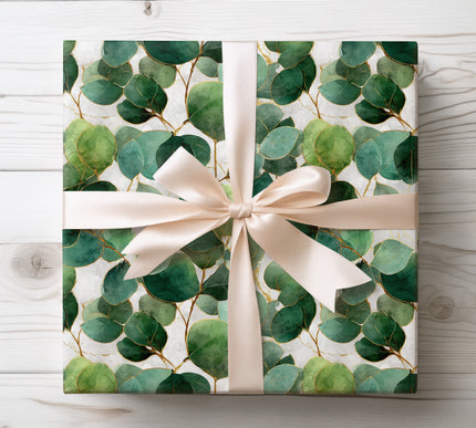 Embrace nature with Eucalyverdra wrapping paper, decorated with gold-lined eucalyptus leaves. Perfect for weddings, holidays, and elegant gifting.