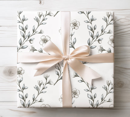 Add understated beauty with Silversage Bloom wrapping paper, featuring silver-toned florals on a clean white background. Perfect for elegant gifting.