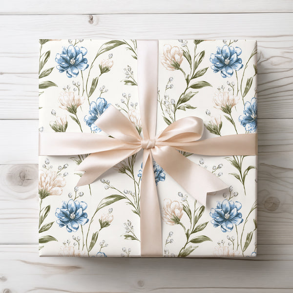 Petalwhisper Dusk – Elegant floral design with blue and cream blossoms on ivory wrapping paper