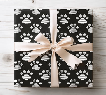 Celebrate your furry friends with Arctic Paws, a black and white knit paw print wrapping paper. This cozy, sweater-style design is perfect for dog lovers, pet-themed Christmas gifts, or winter birthdays. Available in matte or glossy finish, this festive wrap adds warmth and charm to every present. 