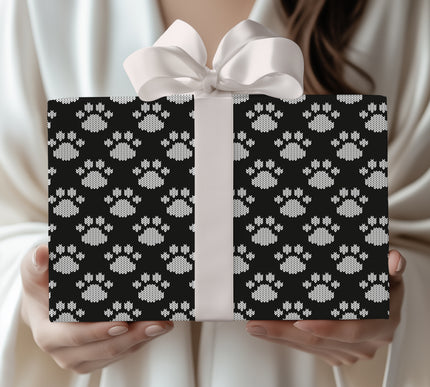 Celebrate your furry friends with Arctic Paws, a black and white knit paw print wrapping paper. This cozy, sweater-style design is perfect for dog lovers, pet-themed Christmas gifts, or winter birthdays. Available in matte or glossy finish, this festive wrap adds warmth and charm to every present. 