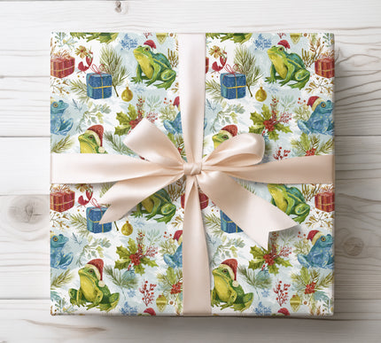 Add whimsical charm with Mistletoad, a wrapping paper featuring cheerful frogs in Santa hats. A fun and quirky choice for holiday presents. 