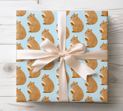 Adorable capybara Christmas wrapping paper featuring cute cartoon capybaras eating nuts with Santa hats — perfect for kid’s gifts, holiday presents, and festive packaging. 