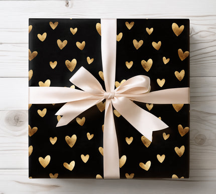 Minimal gold foil heart print on black wrapping paper 