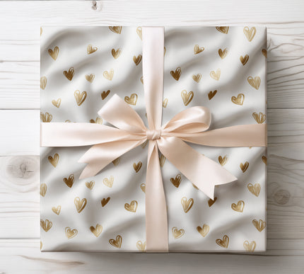 Gold foil scribble hearts on white wrapping paper 